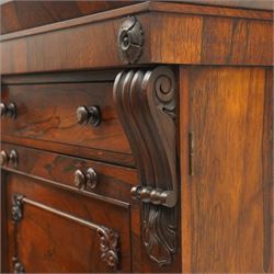 Victorian rosewood Wellington secretaire chest, the projecting stepped cornice over a banded frieze with moulded rosette mounts, single drawer over a secretaire fall-front opening to reveal a maple lined interior with assorted pigeonholes and correspondence drawers, over a lappet carved lower edge with four graduating drawers below, each with turned pull handles, flanked by hinged lock to the right and plain stile to the left surmounted by reeded corbels, raised on a skirted base