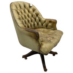 Early 20th century swivel desk chair, upholstered in buttoned sage green leather with studwork, on adjustable action with castors