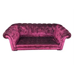 Contemporary Chesterfield design two-seat sofa, upholstered in fuchsia crushed velvet with a ribbed and tufted design, the rolled arms and deep-buttoned backrest raised on square block supports