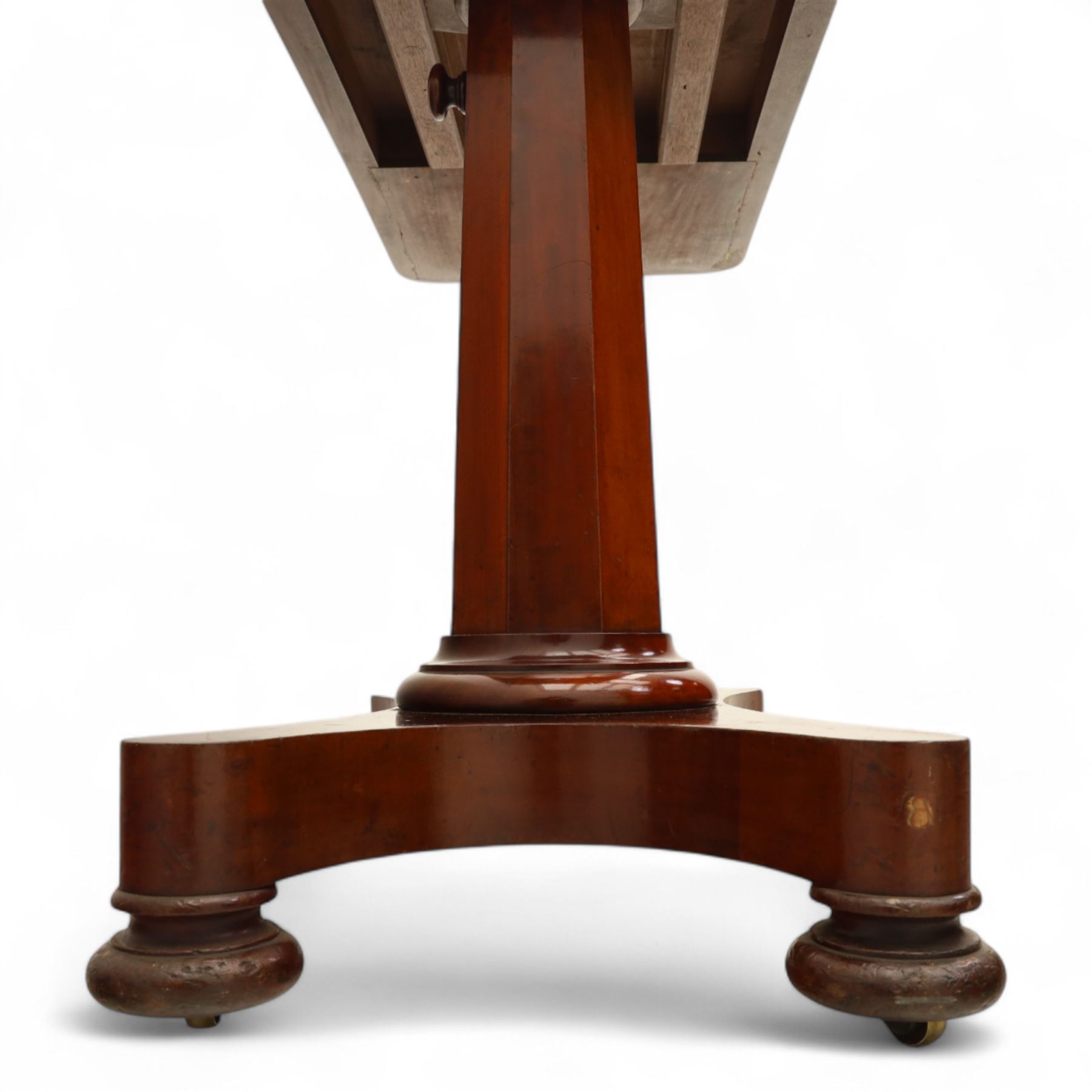 William IV mahogany reading table, the rectangular top with rounded corners and moulded edge, one end fitted with two hinged adjustable reading slops with two rests, the sliding top with a sprung stay mechanism, supported on a single tapered faceted column  with turned collar on a quatreform base with compressed bun feet