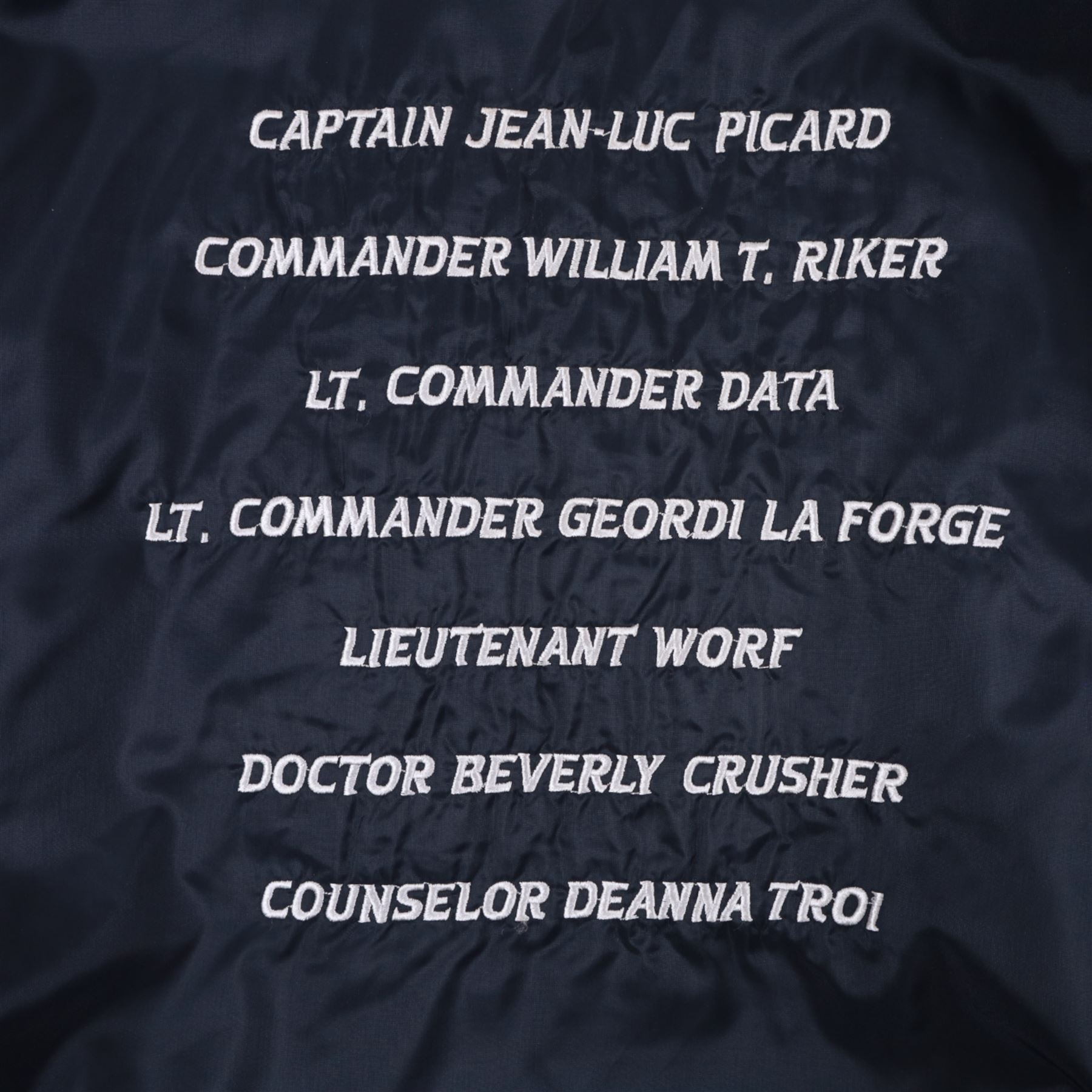 Star Trek The Next Generation 10th anniversary jacket, leather sleeves and collar with embroidered decoration throughout, including 10th anniversary emblem to back, 'Star Trek The Next Generation' to collar, 'Paramount Pictures Stages 8,9 & 16' to front and seven character names to interior, in size XXXXL, purchased in 1990s from Star Trek Experience Las Vegas