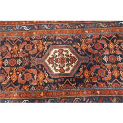 Large vintage Persian Hamadan indigo ground runner rug, the busy field with central ivory medallion and spandrels, surrounded with Herati motifs and stylised plant symbols, with multiple floral decorated guard bands