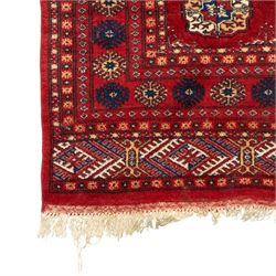 Two hand-knotted rugs, comprising Persian floral rug, dark blue ground decorated with scrolling foliage and flowerheads within a red floral border (H 208cm, W 134cm); Bokhara type rug, red ground with repeating gul motifs and geometric guard borders (H 174cm, W 94cm)