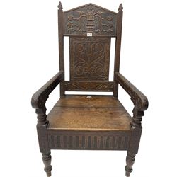 17th century design oak wainscot chair, the back profusely carved with scrolling foliate motifs, the arms carved with repeating guilloche decoration over an arcade apron and turned supports
