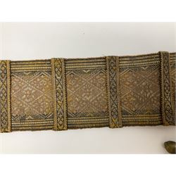 Late 19th century Yemeni Tuza jambiya as worn by religious elite, the 20.5cm curving blade with raised medial ridge, the horn hilt with pique style studwork, in a leather wrapped wooden scabbard with pierced metal mount and leather belt applied with embroidered 'gold' and 'silver' thread work panel; dagger L36cm overall, belt L84cm