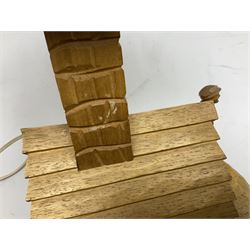 Mid 20th century Paul Caron carved table lamp, modelled as man standing before an oven, the chimney supporting the panelled shade, the base signed P.E. Caron, H42cm