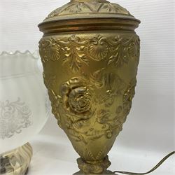 Gilt metal table lamp, heavily embossed with flowers and butterflies, with fluted frosted glass shade, H56cm