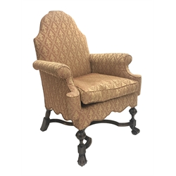  Georgian style walnut framed upholstered armchair, with arched back, outsplayed arms and shaped frieze on moulded scroll supports joined by a cross stretcher  