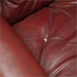 Impressive pair of mid-Victorian oak throne or hall chairs, arched backs on fluted supports with a deep buttoned upholstered panel and upholstered curved arms over fluted seat rails and tapering turned front legs with original brass and brown porcelain castors, and out-swept rear supports