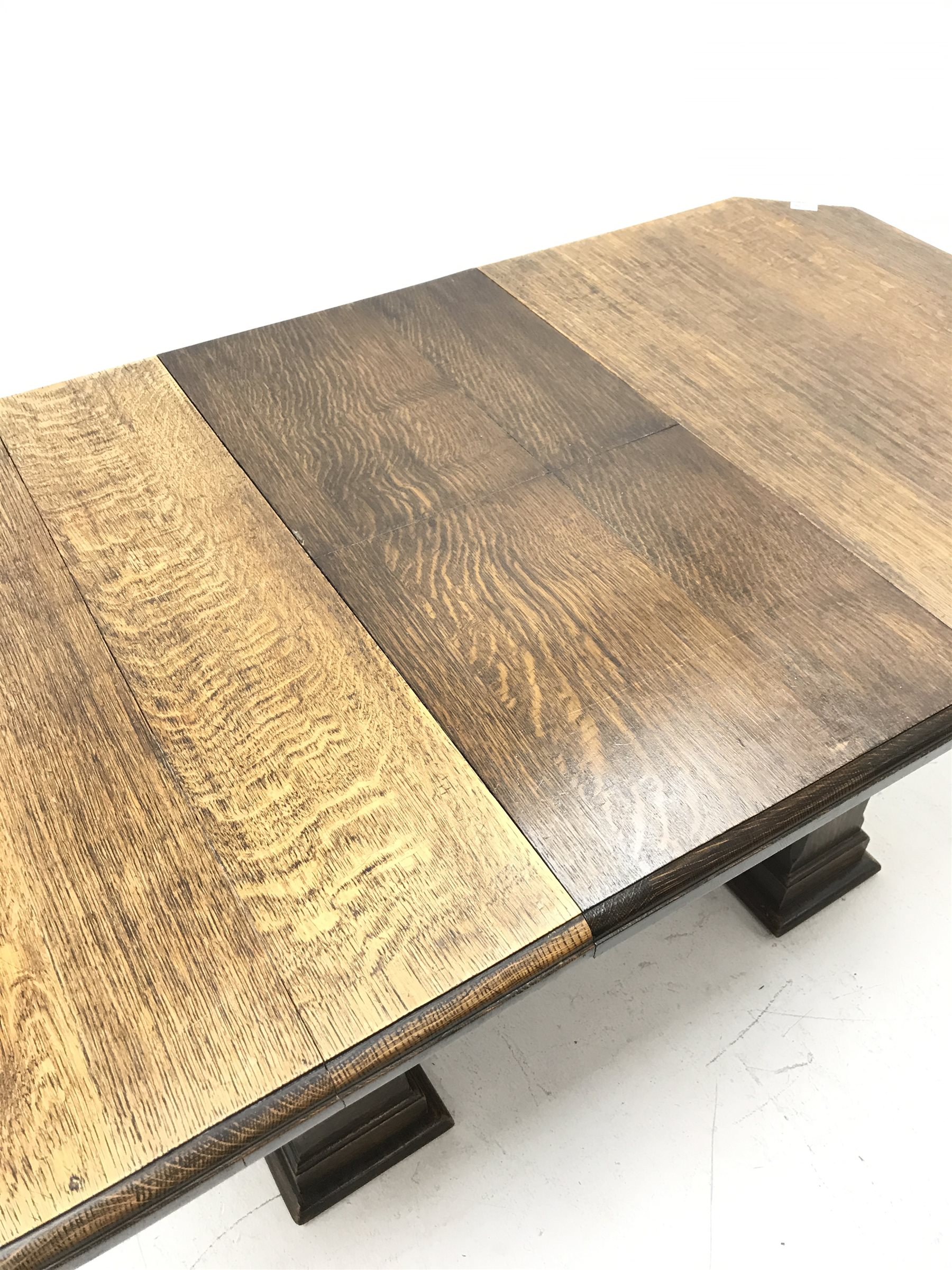 'The Celerity Patent' - Early 20th century oak extending dining table, canted rectangular moulded top with foldout leaf, on two rectangular box supports, 91cm x 122cm - 167cm, H74cm