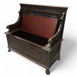 Late Victorian carved oak hall bench, the panelled back deeply carved with scrolling acanthus and central cartouche, hinged seat with foliate and shell motifs, scroll carved arm supports, on short cabriole front legs