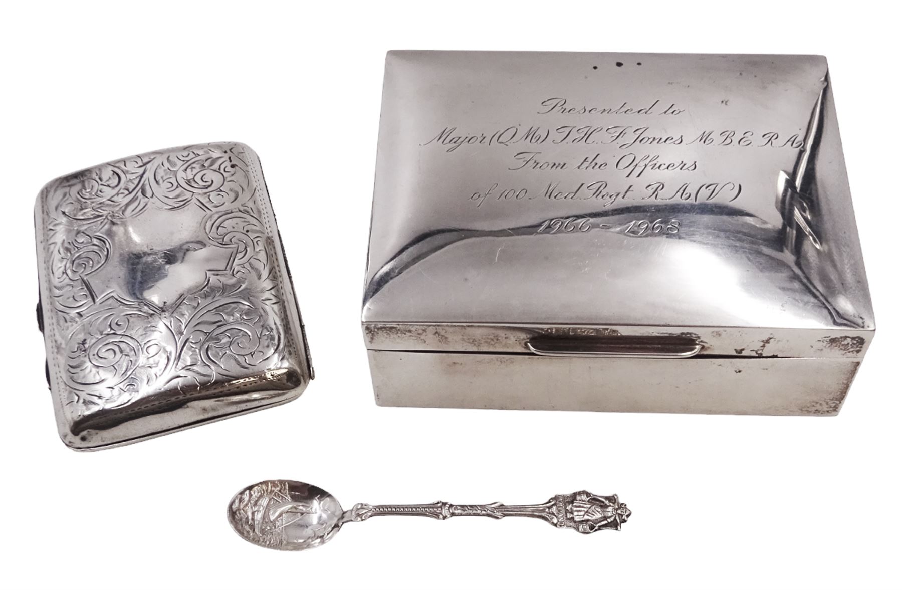 Modern silver mounted cigarette box, of plain rectangular form, with personal engraving to hinged cover, opening to reveal soft wood lined interior, H3.8cm, W21.5cm, hallmarked Padgett & Braham Ltd, London 1967, together with a silver cigarette case, with engraved C scroll decoration, hallmarked Joseph Gloster Ltd, Birmingham 1917 or 1942 and a silver souvenir spoon