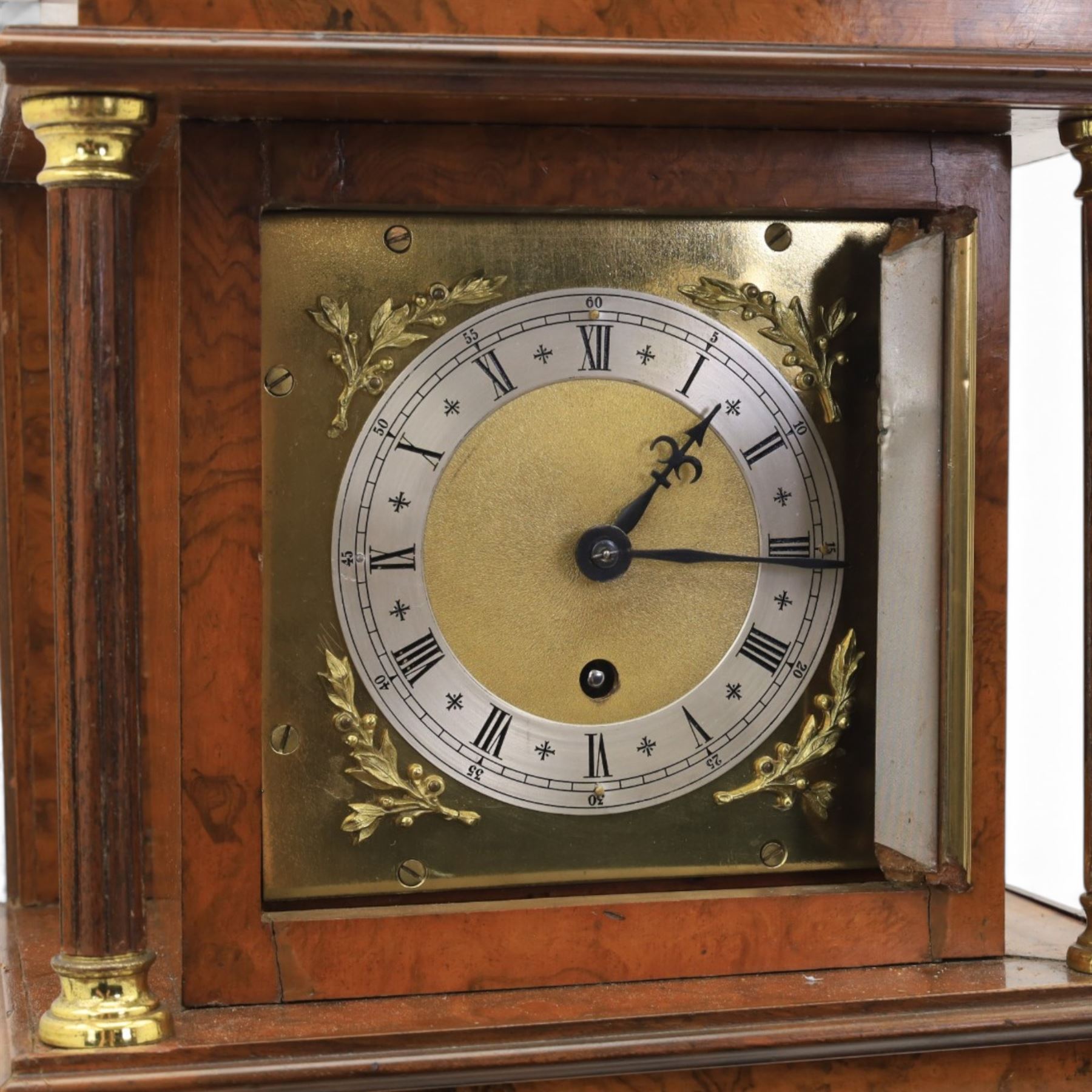 Early 20th century walnut small longcase clock, brass dial with silvered Roman numeral chapter ring and pierced black hands, the figured walnut case with shaped projecting hood, long moulded trunk door and stepped plinth base