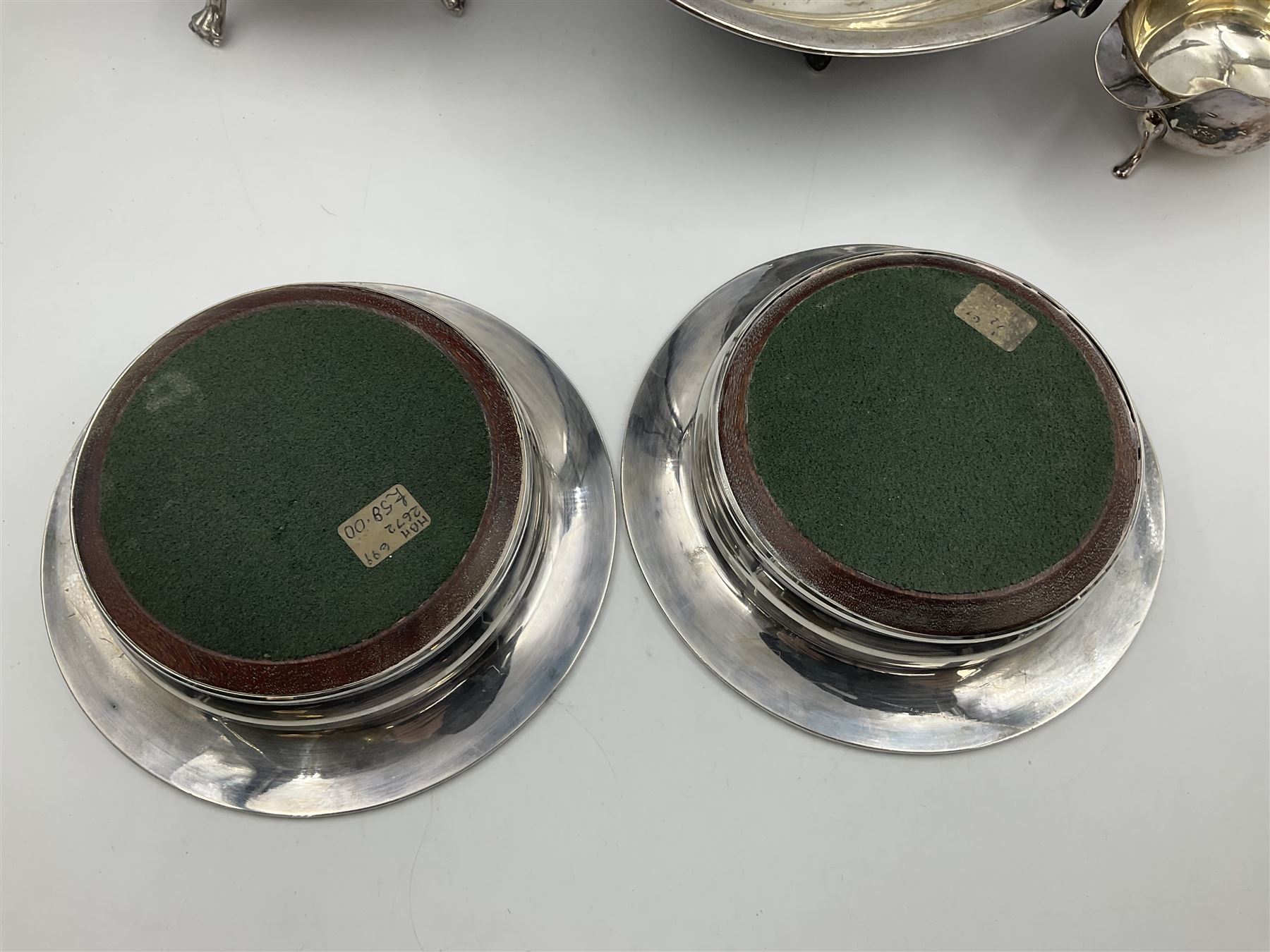 Silver plated seven bar toast rack by Mappin & Webb, together with other silver plated items including pair of bottle coasters, swing handled baskets and two sauce boats