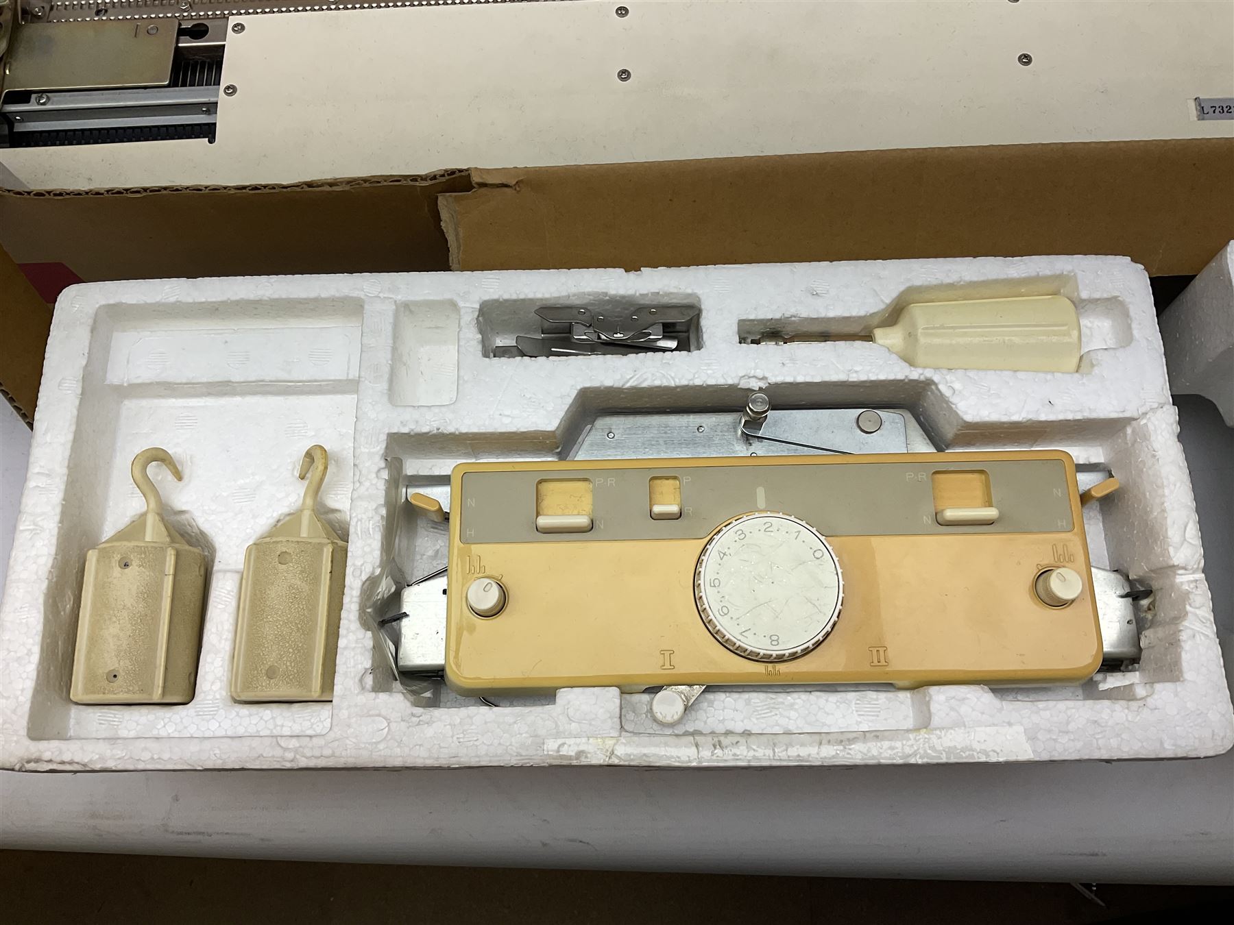  Brother cased knitting machine model KH-890 together with Brother Ribbing attachment model KH-850, knitting machine yarn cones in assorted colours, selection of knitting patterns etc