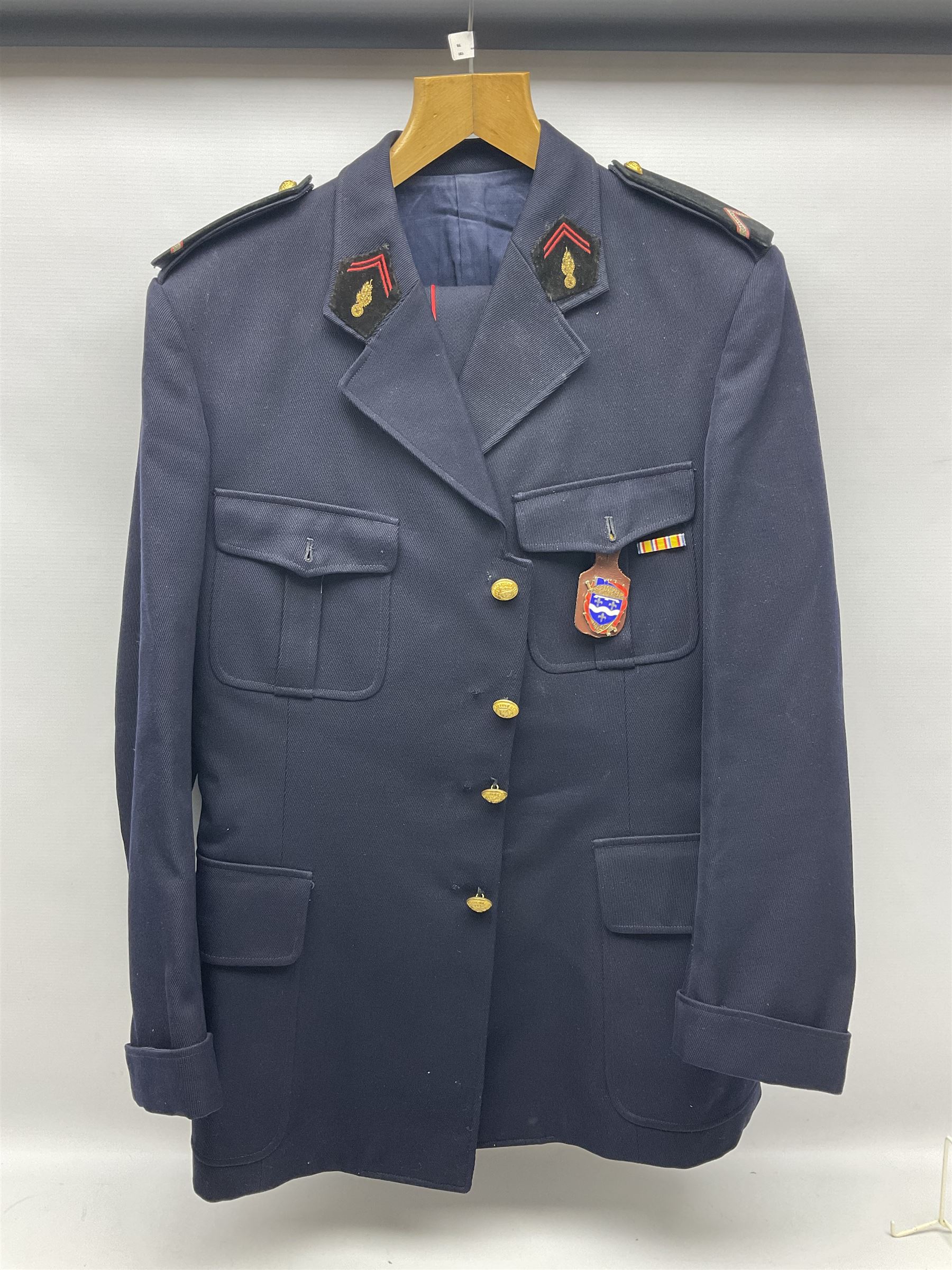 Mid 20th century French Ugeco Nantes first class dress navy blue uniform with ribbon bar with cap, and quantity of Sapeurs Pompiers patches, Sapeurs Pompiers de Caen belt buckle etc