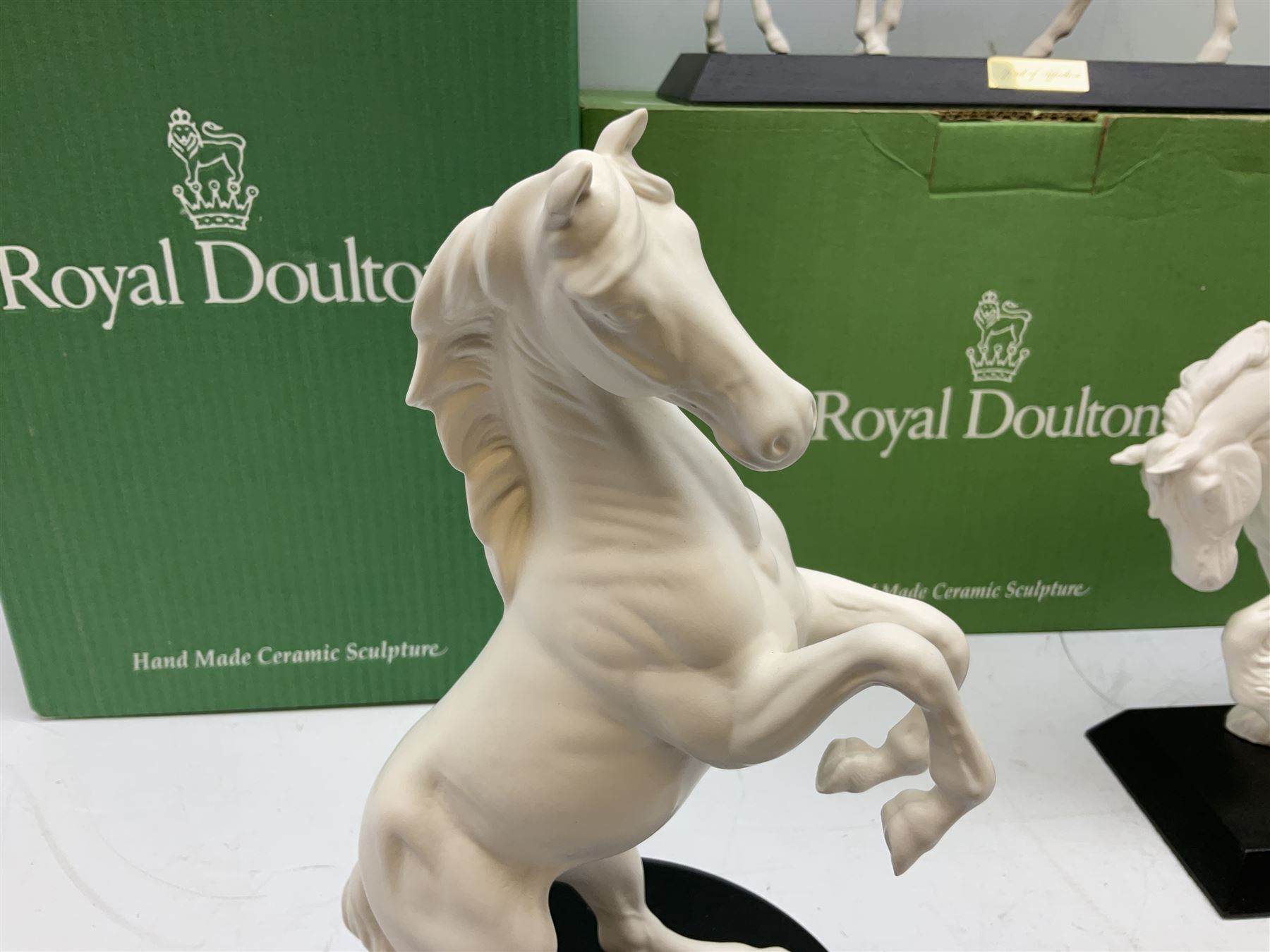 Five Beswick and Royal Doulton horse figures in matt white on black plinths, comprising of  Spirit of Affection no. 2689/2536, Springtime no.2837, Spirit of peace no.2916, Spirit of earth no.2914 and Spirit of the wild no. 183, together with a composite figure of a horse (6)