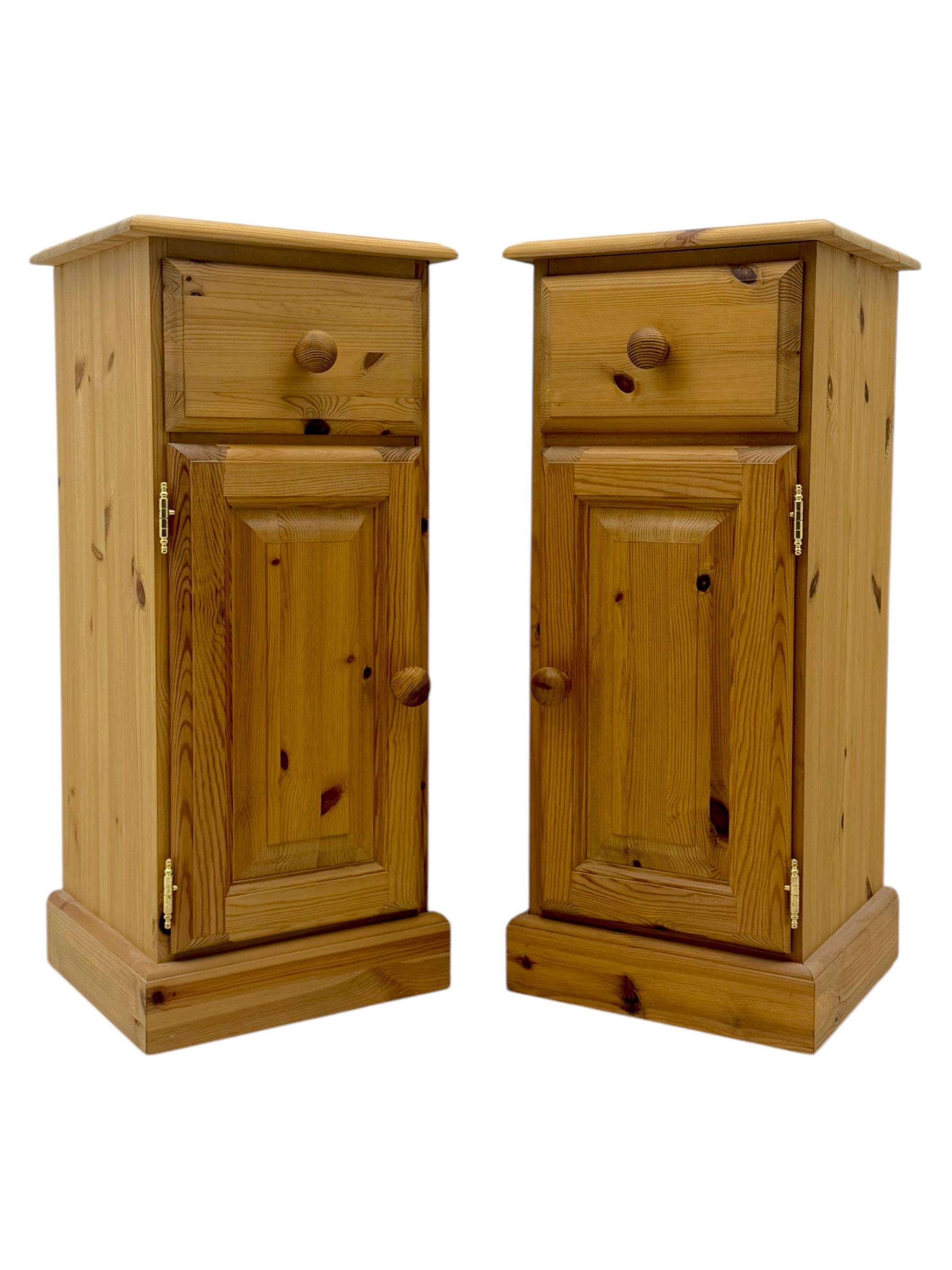 Pair of solid pine traditional design bedside cabinets, one draw above a cupboard with inner shelf
