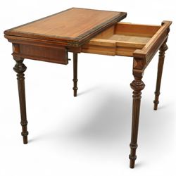 19th century mahogany fold-over card table, the crossbanded rectangular top opening to reveal an inlaid games centre with chessboard and backgammon designs, raised on turned and reeded legs with extending rear supports