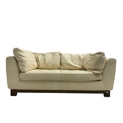 Roche-Bobois - two seat sofa, upholstered in ivory leather with buttoned seat cushions, raised on a stained beech base with bracket feet