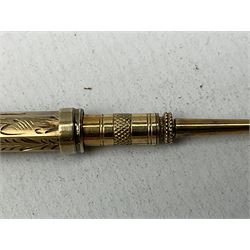 Victorian gold propelling pencil of hexagonal form decorated with foliate engraving and stone set terminal, L9cm (unmarked, tested to 7.8K)
