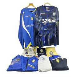 Fourteen items of replica sporting clothing including Leeds United football club shirts, England jerseys etc