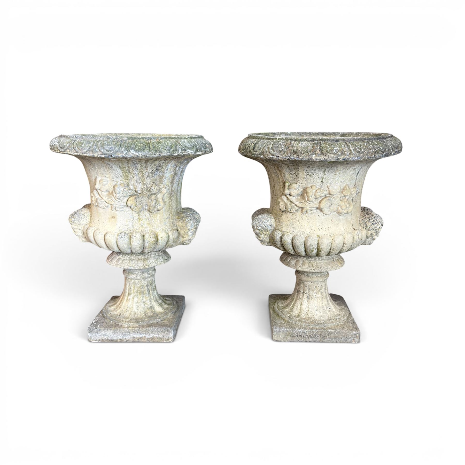 Pair of large cast stone garden urns, circular form with egg and dart border, tapering gadrooned bowl with cast handles and detail