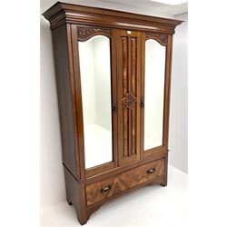 Late Victorian double walnut wardrobe, projecting cornice, two bevel edge mirror doors above single drawer, shaped solid end supports