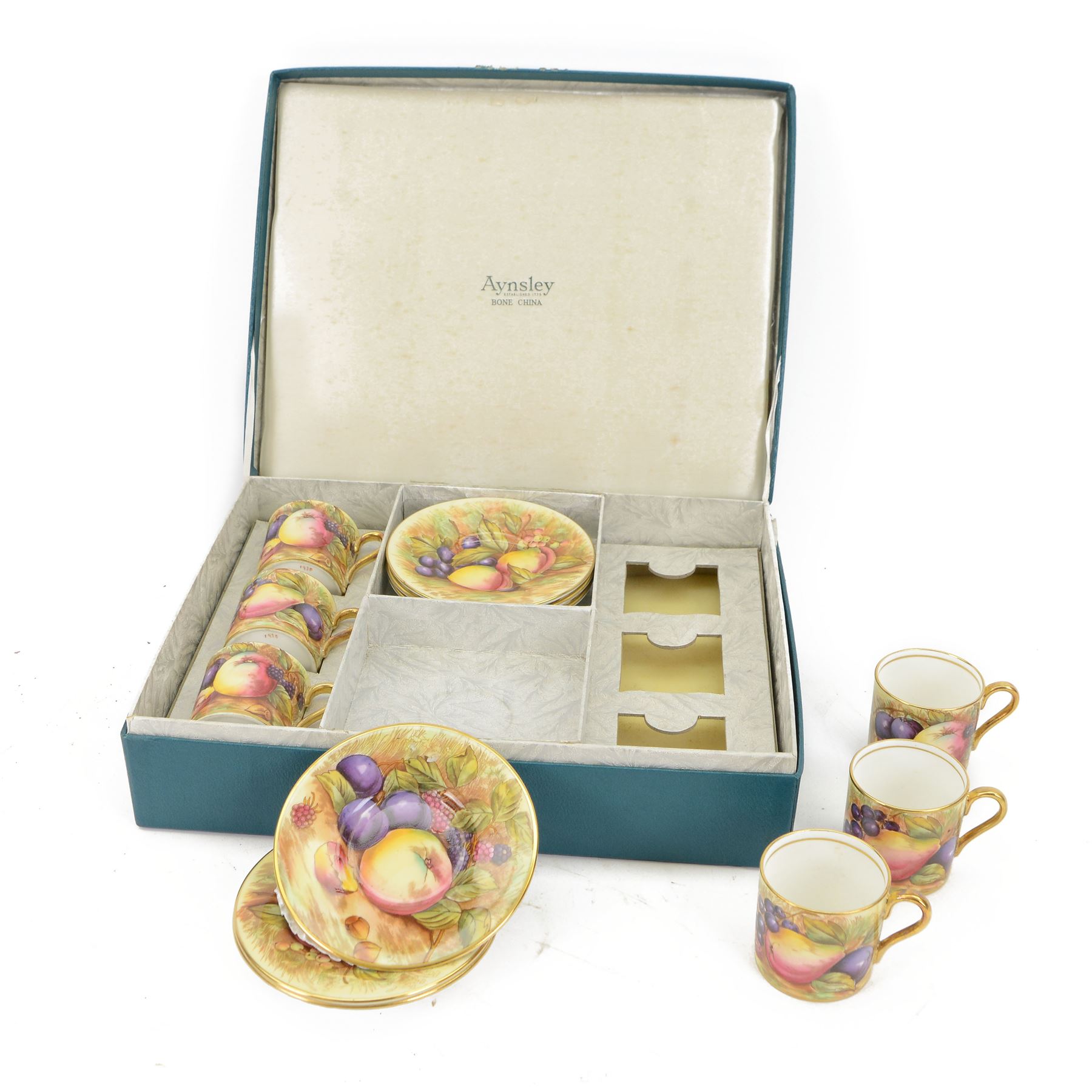 Aynsley fruit pattern, set of six coffee cans and saucers, gilded and decorated with fruit signed by N Brunt, in the original box, can H6cm