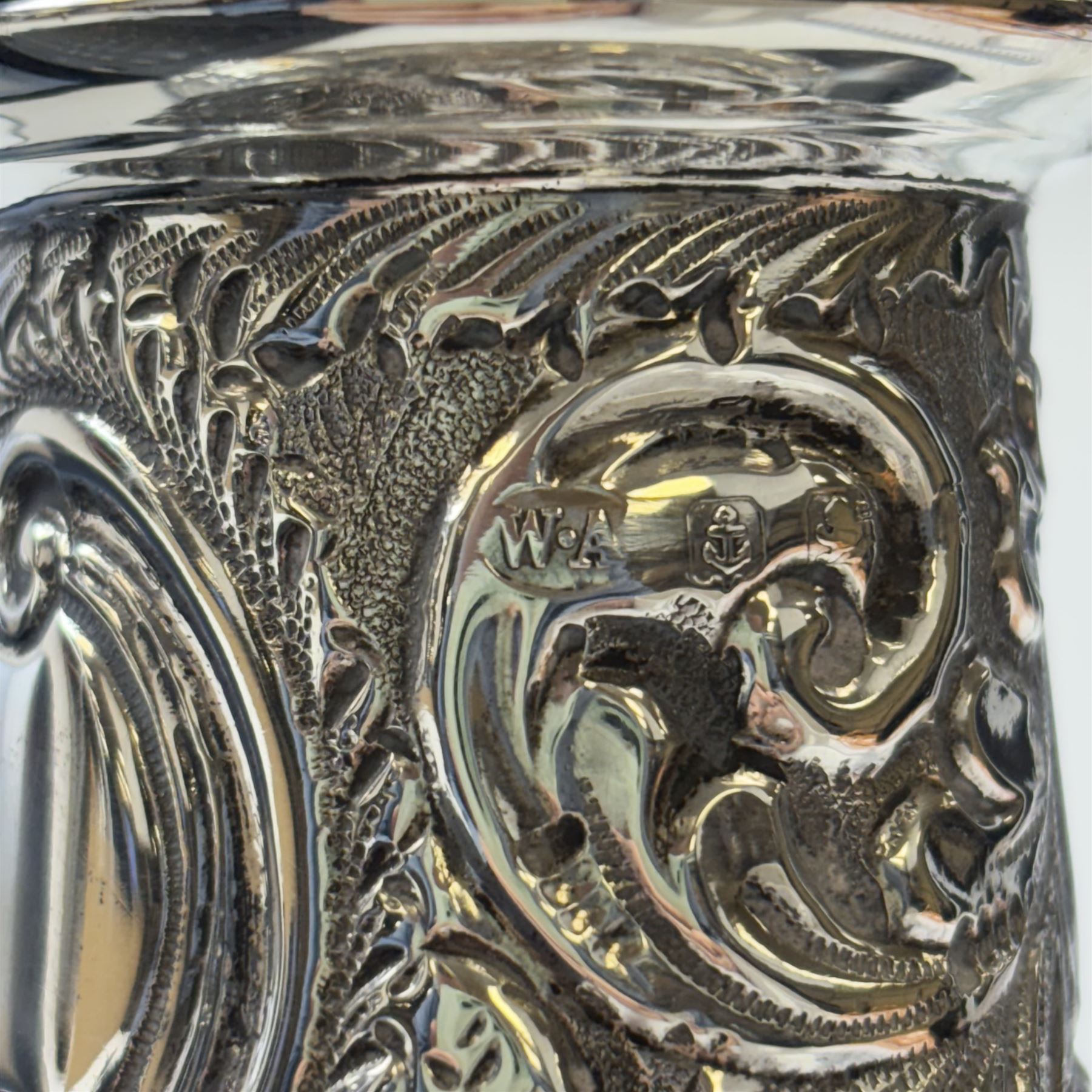 Edwardian silver sugar caster, of typical waisted form profusely embossed with floral and foliate decoration, the removable pierced cover with fluted finial, upon a circular stepped foot, hallmarked William Aitken, Birmingham 1901, H23cm