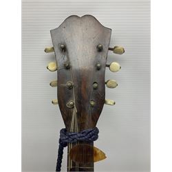 Late 19th/early 20th century Italian lute back mandolin with segmented back and spruce top; bears maker's label for Pietro Tonelli Napoli; together with a mandolin instruction booklet and a folding music stand L60.5cm
