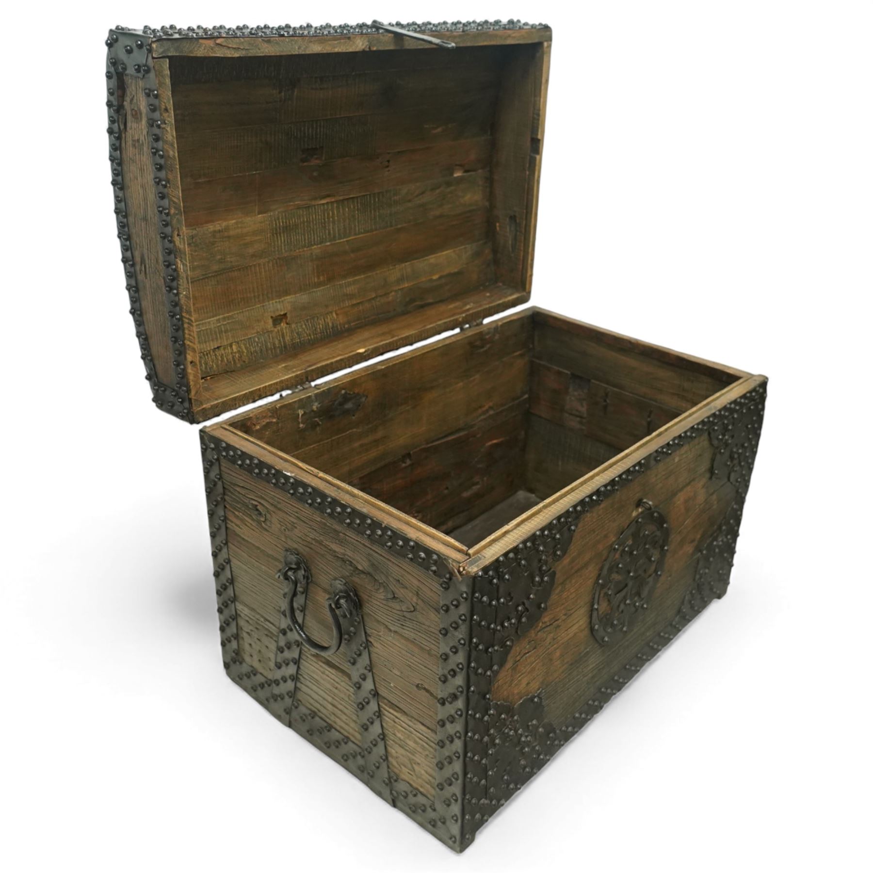 20th century Chinese camphorwood chest, the hinged lid opening to a plain interior, the exterior fitted with heavy iron strapwork, studded mounts and shaped corner plates, central circular lock escutcheon, with iron carrying handles