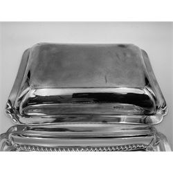 Early 20th century silver entree dish and cover, of rectangular form with shaped corners and oblique gadrooned borders to base and cover, the cover with loop 'bamboo' handle, hallmarked Thomas Bradbury & Sons Ltd, Sheffield 1930, including handle H10.5cm L24.5cm