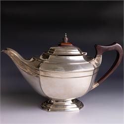 Art Deco three-piece silver tea service, comprising teapot with removable tea strainer, open sucrier and milk jug, all of hexagonal form, the teapot with wooden handle and finial, all hallmarked James Deakin & Sons, Sheffield 1925, together with a matched pair of silver sugar tongs, hallmarked