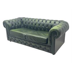 Two seat Chesterfield design sofa bed, upholstered in emerald green leather with deep-buttoned detailing, rolled arms, two loose seat cushions, and pull-out 