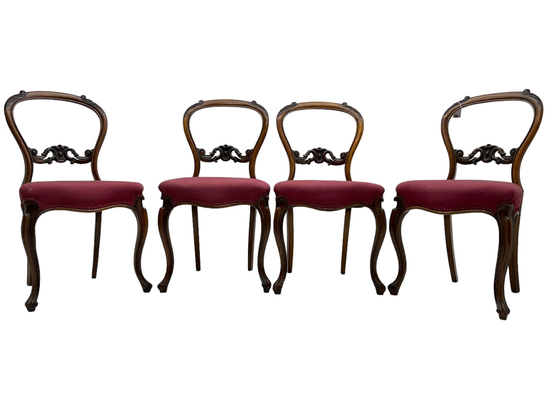 Set of six Victorian rosewood dining chairs, the balloon back carved with foliage scrolls, cartouche carved middle rail with extending scrolls, the seats upholstered in pink fabric, on carved cabriole supports with scrolled terminals 