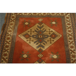  Turkish red ground rug, two equal set medallions with repeating star border, 126cm x 180cm  