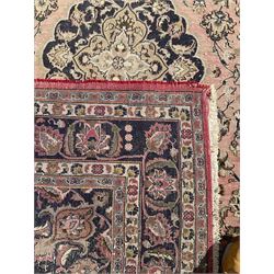 Persian Kashan carpet, blue shaped medallions and spandrels, the field decorated with interlacing branch and stylised plant motifs, repeating floral design borders