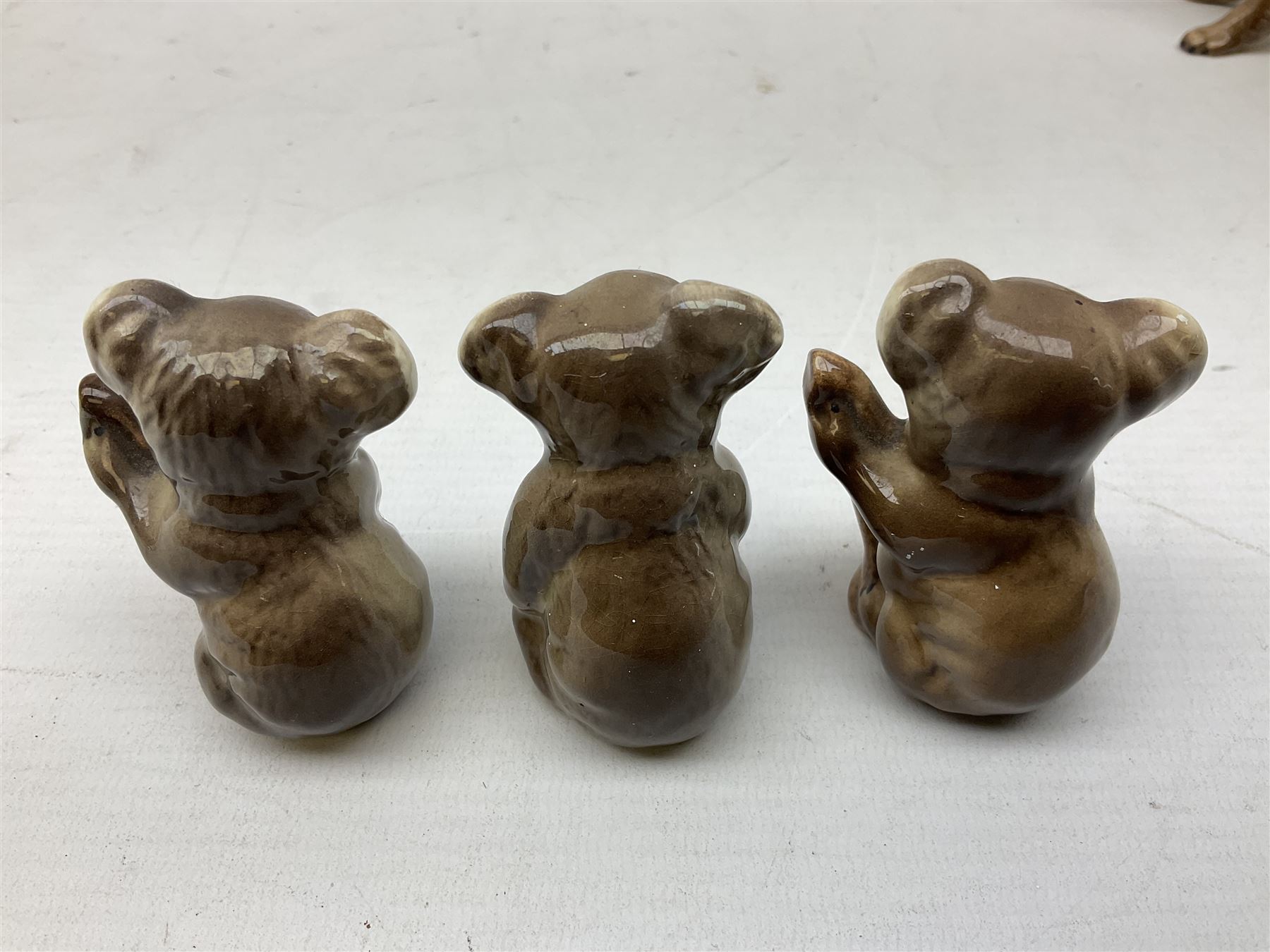 Five Beswick Koala bears, comprising two large koalas no.1038, koala on branch no. 1039 and baby koala no.1040