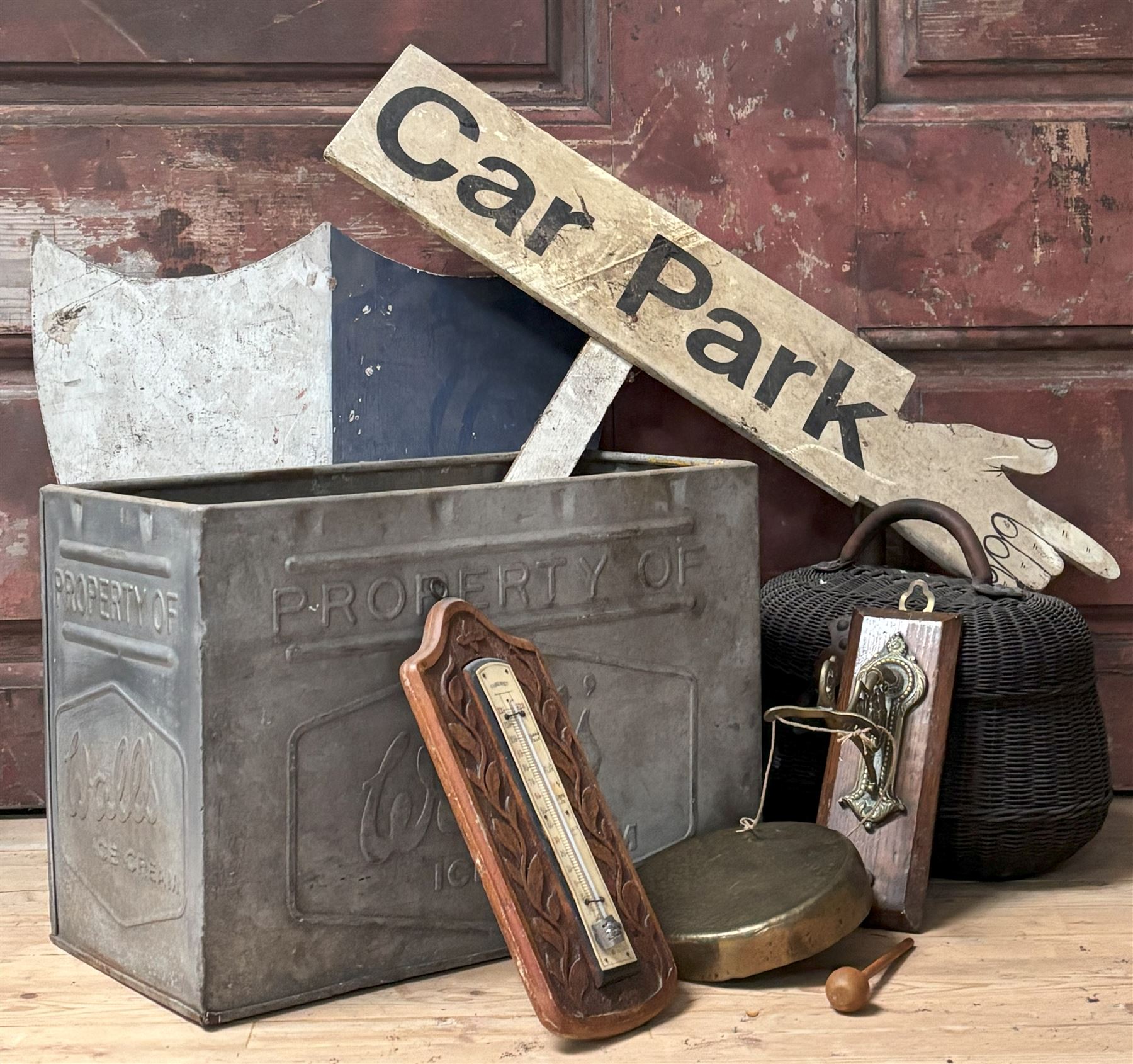 Vintage Walls ice cream container, (W43cm) together with a painted carpark finger board, a painted shield, wicker creel box, an oak and brass dinner gong, and a carved oak framed thermometer (6) - COLLECTION BY APPOINTMENT FROM: The White House, Thirsk Road, Easingwold, York, YO61 3NF - CALL 01723 507111 TO ARRANGE