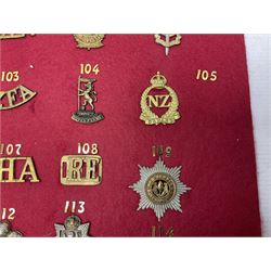Forty glengarry and cap badges and shoulder titles including Gordon Highlanders, Canada and Canadian Field Artillery, New Zealand Field Artillery and Rifle Regiment, Shropshire Light Infantry, 14th/20th Kings Hussars, 17th Lancers, Northamptonshire Yeomanry, Royal Lincolnshire, Special Air Service, 19th Alexandra P.W.O. Hussars etc; mounted on two boards for display (2)