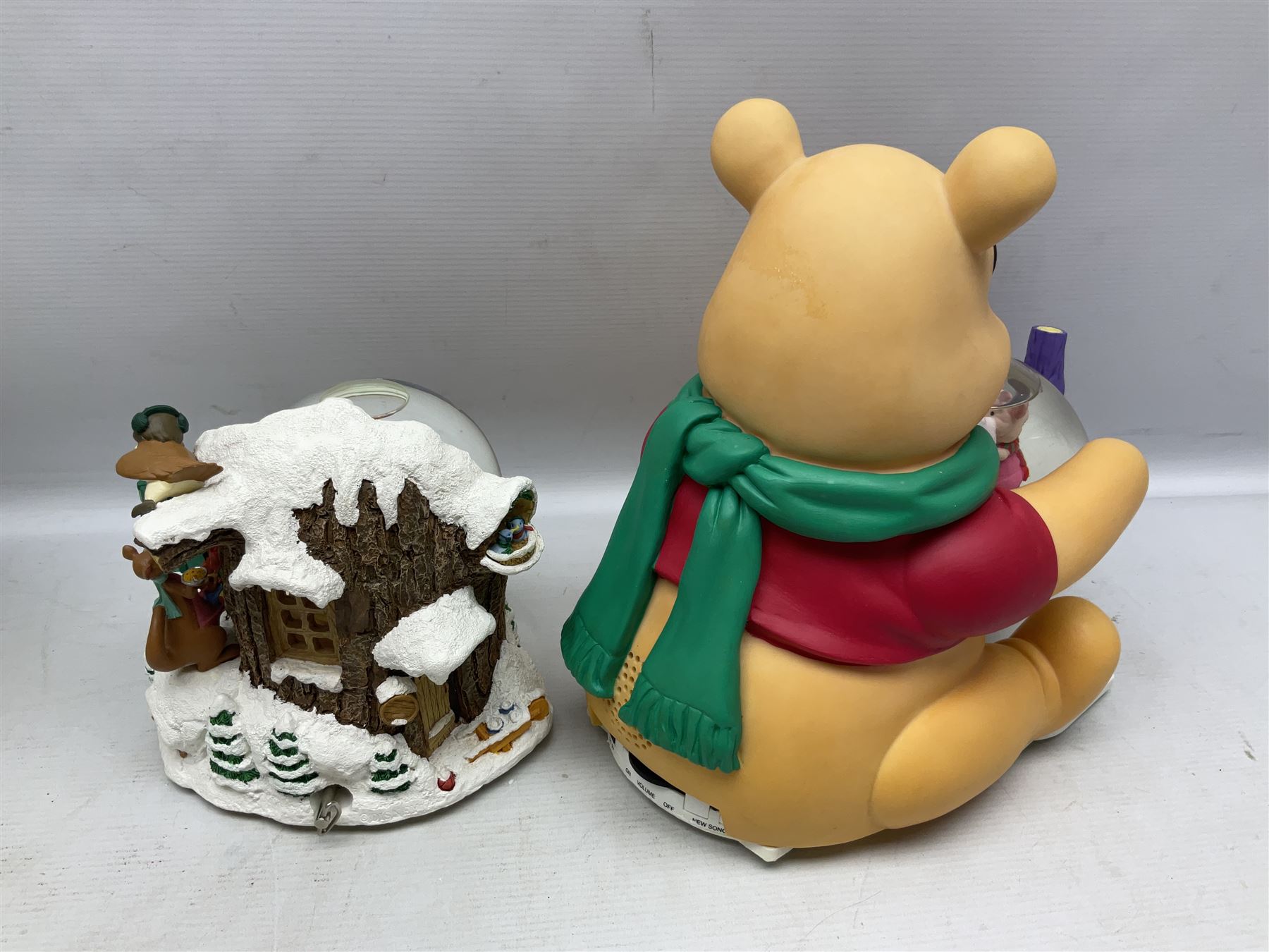 Six Disney Winnie the Pooh Christmas snow globes, comprising large Mr Christmas Holiday Snowfall, An Enchanted Christmas, It's A Small World Christmas 1994,  Tree Trimming, 1995 Christmas At Our House and Christmas Band Concert, together with Mr Christmas Holiday Go Round, all with boxes (7)