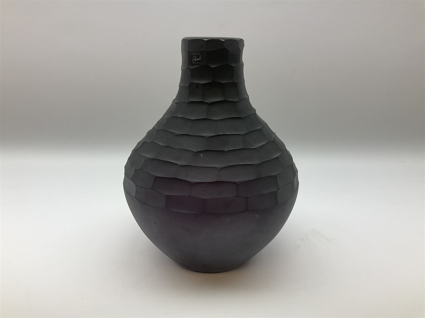 Two Dartington Studio Fossae Punched glass vases, in black and grape
