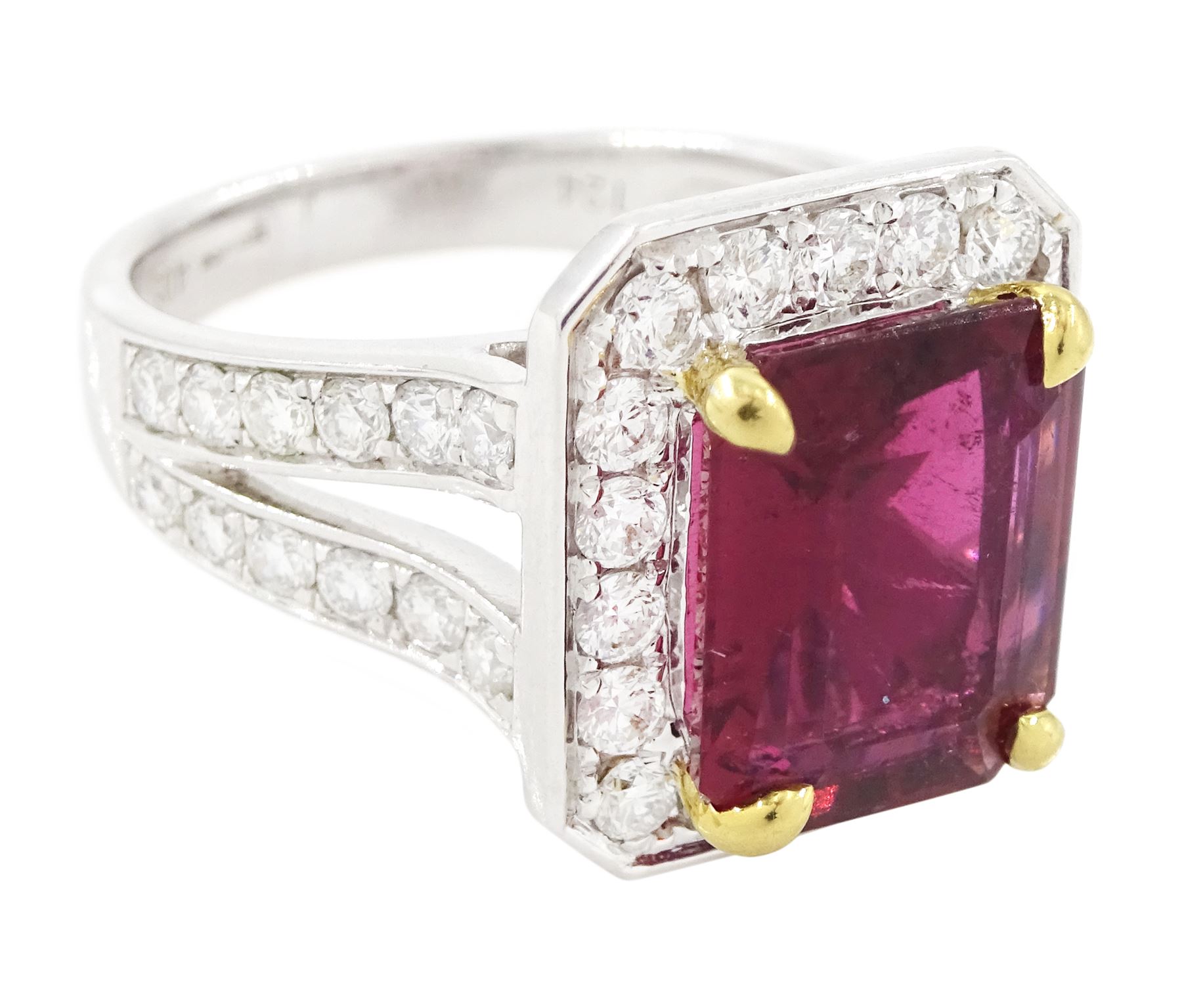 18ct white gold rubellite tourmaline and diamond cluster ring, single octagonal cut tourmaline of 4.05 carat, four claw set in yellow gold, surrounded by  round brilliant cut diamonds, with split diamond set shoulders, London 2013, total diamond weight 1.24 carat