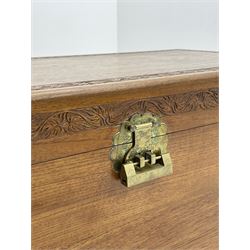 Late 20th Century camphor wood chest, single hinged lid with carved foliage detailing, ogee bracket supports