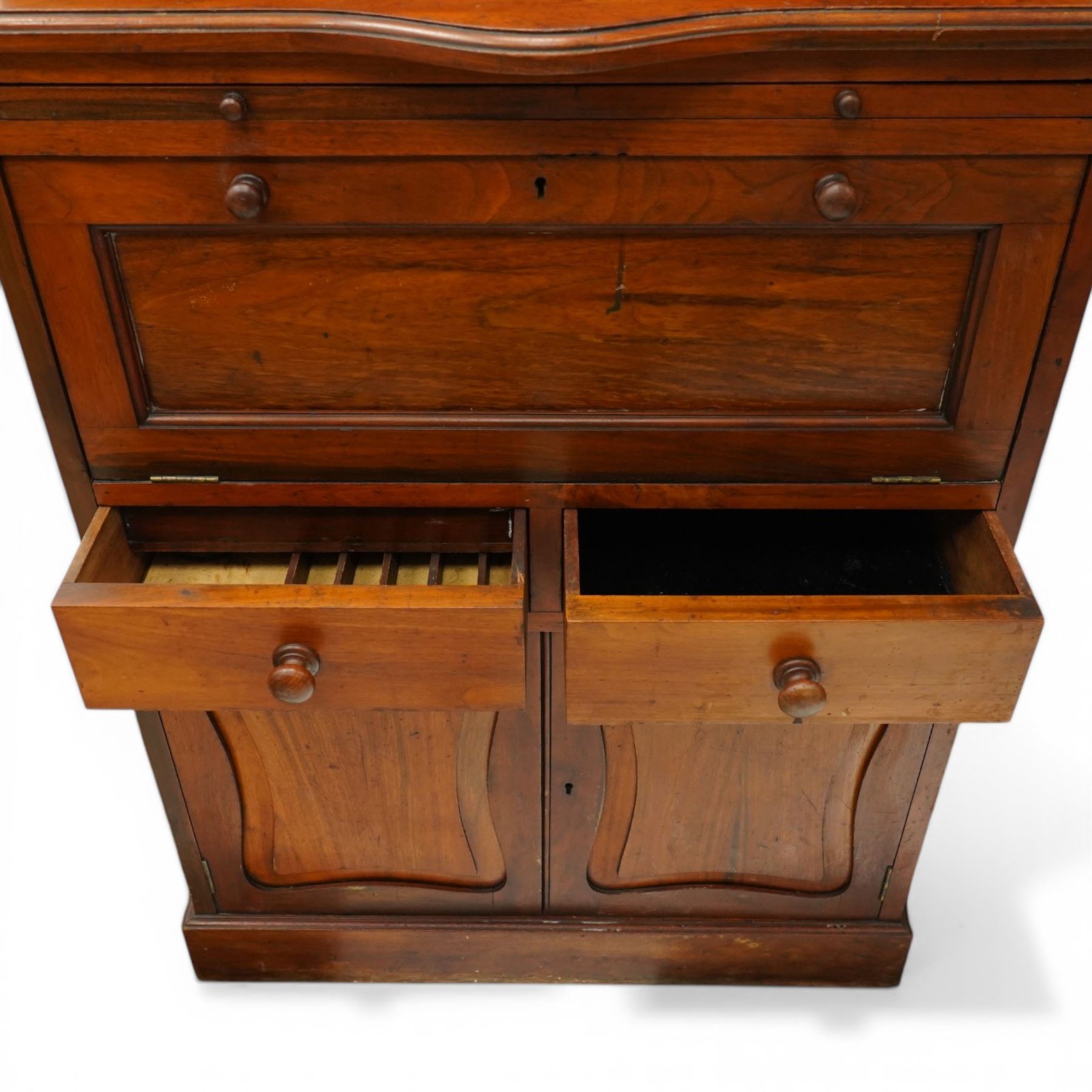 19th century walnut dentist cabinet, galleried top above twin cupboard doors with mirrored interior, recessed mirrored section, two banks of five graduated drawers, shaped section with brushing slide above a fall front, two short drawers and twin cupboard doors, on a plinth base 