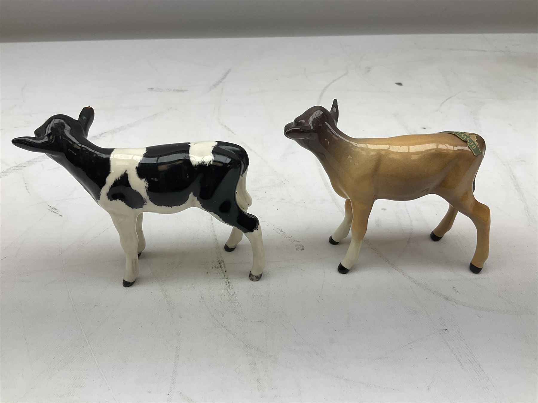 Seven Beswick cow figures, to include Friesian bull Ch. ''Coddington Hilt Bar'' no. 1439a, Friesian cow Ch. 'Claybury Leegwater' no. 1362a and Friesian calf no. 1249C, Aberdeen Angus calf 1827a, Jersey cow no. 1345 etc, all with printed mark beneath  