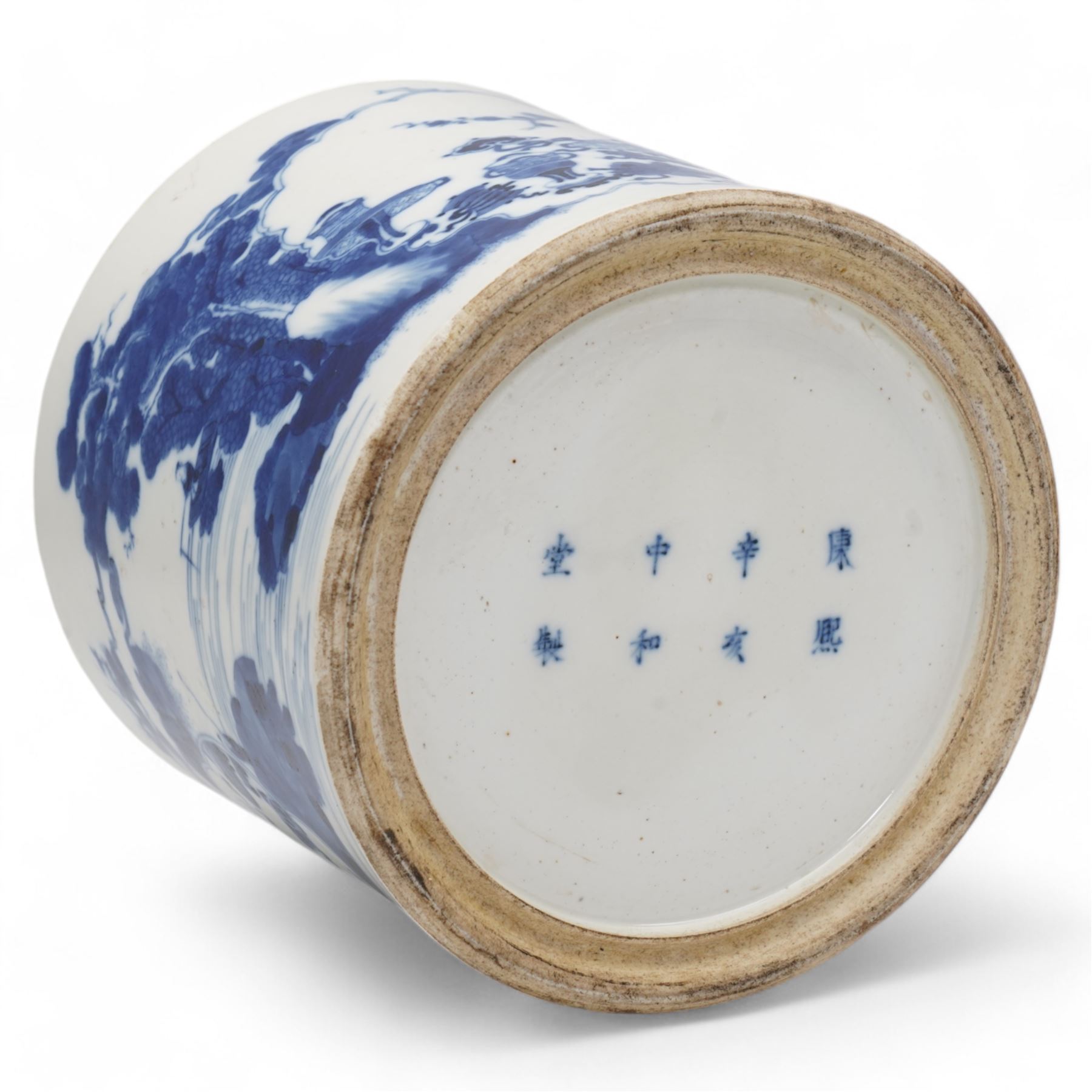 18th/ 19th century Chinese porcelain blue and white bitong or brush pot, of slightly tapering cylindrical form decorated with cartouches of treasured items and figures in a landscape scene, with eight character Kangxi marks beneath, H17cm x D19.5cm 