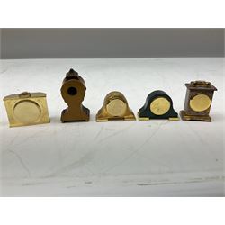 Collection of miniature clocks, predominantly with quartz movements, to include example modelled as an armchair, Edinburgh crystal glass example, clock modelled as a flower, sewing machine etc