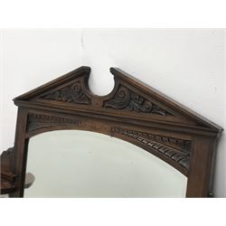 *Late Victorian walnut mirror back, sloped arch pediment carved with scrolled acanthus leaves above arched bevelled mirror, set with floral tiles, W104cm, H80cm